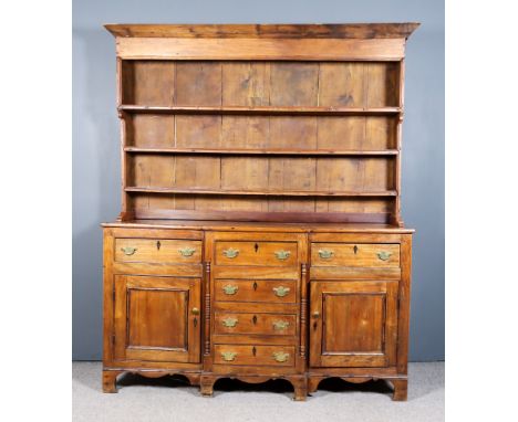 An Early 19th Century Fruitwood Breakfront Dresser Base, fitted three frieze drawers above three dummy central drawers and fl