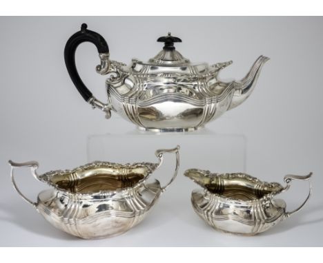 An Edward VII Silver and Silver Gilt Oval Three-Piece Tea Service, by Joseph Rodgers &amp; Sons, Sheffield 1904, with shell a