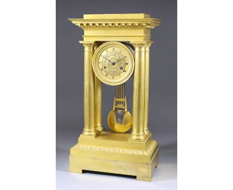 A 19th Century French Empire Gilt Brass Cased Mantel Clock, the 3.625ins diameter gilt dial with Roman numerals, the dial cen