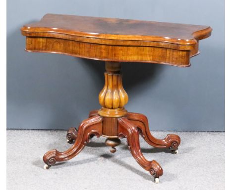 A Victorian Burr Walnut Card Table of Serpentine Outline, the baize lined folding top with matched veneers and moulded edge, 