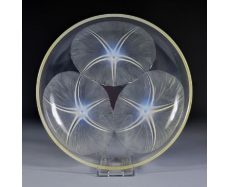 A Lalique Pale Blue Opalescent and Clear Glass Circular Shallow Dish of Volubilis Pattern No. 383, moulded with three lily pa