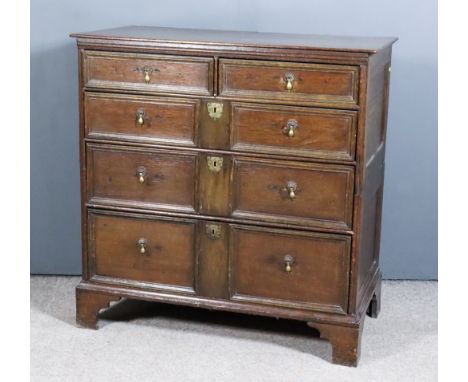 A 17th Century Oak Chest, with plain top and panelled sides, fitted two short and three long drawers, twin moulded and panell