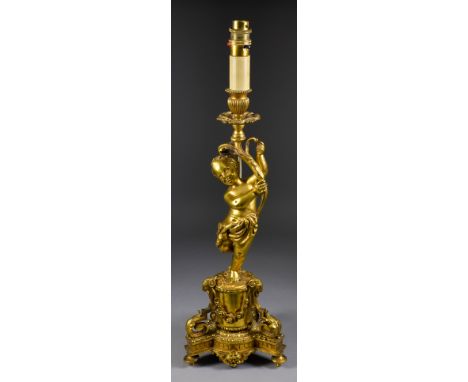 An Early 20th Century French Gilt Brass Electric Table Lamp, the column moulded with a standing figure of Putto holding aloft