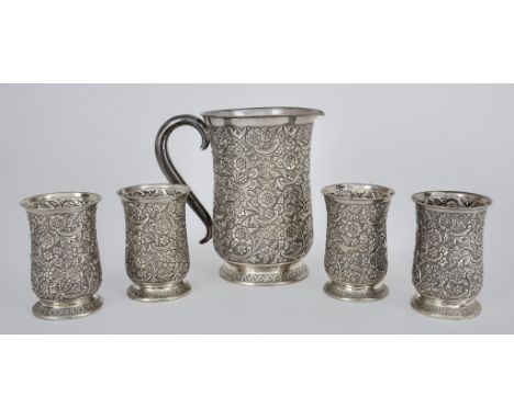 A Near Eastern Silvery Metal Baluster Shaped Lemonade Set, with plain rims, the bodies embossed and chased with floral, leaf 