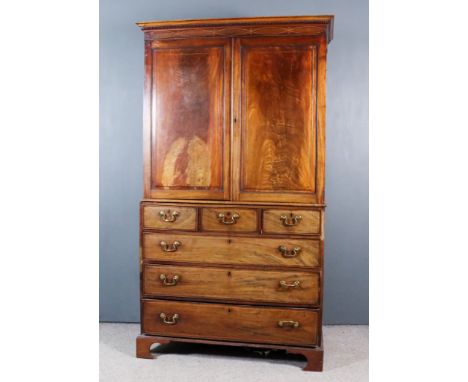 A George III Gentleman's Mahogany Wardrobe, inlaid with boxwood stringings, the upper part with moulded and dentil cornice, f