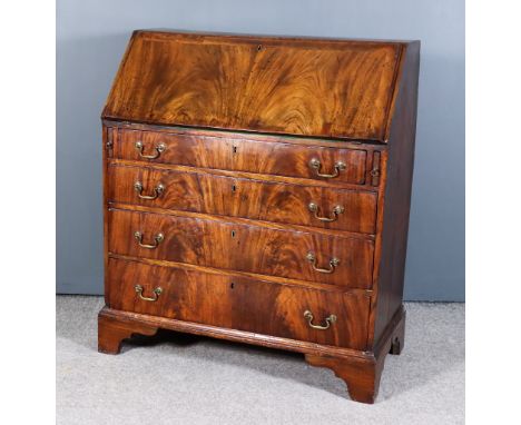 A George III Figured Mahogany Bureau, the slope enclosing fitted interior with central cupboard with six pigeon holes and fou