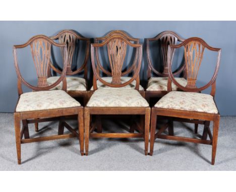 A Set of Six George III Mahogany Shield Back Dining Chairs of "Hepplewhite" Design, the moulded shield backs with fretted spl