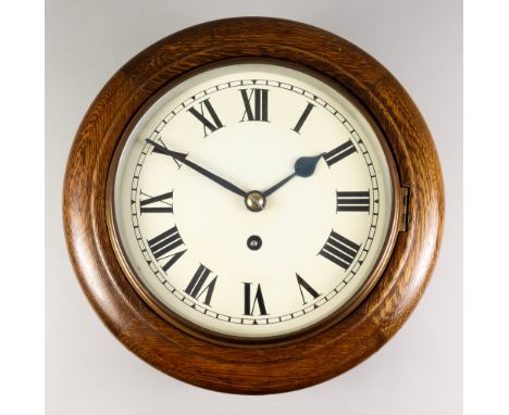 An Early 20th Century Oak Cased Dial Wall Clock, the 8ins white enamel dial with Roman numerals to the eight day fusee moveme