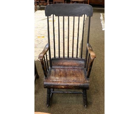 An early 19th century stick back rocking chair