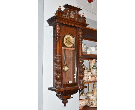 A walnut veneered Vienna type striking wall clock, twin spring barrel movement striking on a gong, 109cm high