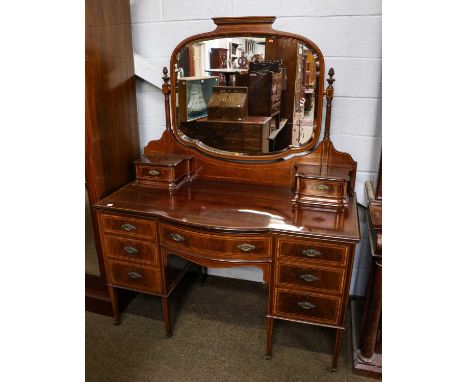 A good quality Edwardian satinwood inlaid mahogany dressing table, the large swiveling mirror plate surmounted by a dentil an