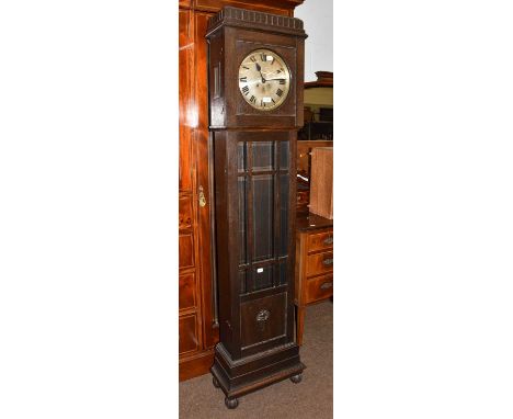 A 1940's oak cased longcase clock, with 10.5'' silver dial housing a three train movement chiming on gongs