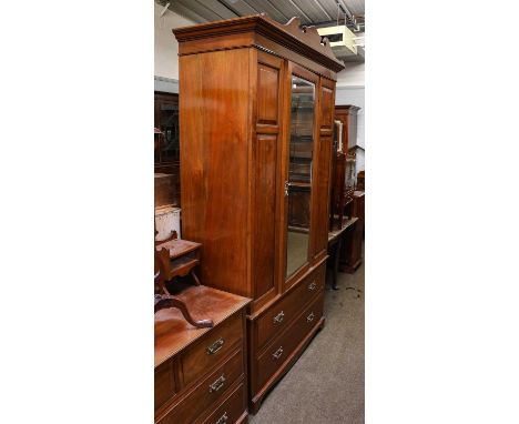 An Edwardian mahogany two-piece bedroom suite, comprising: a mirror fronted wardrobe, 124cm by 52cm by 228cm, and a dressing 