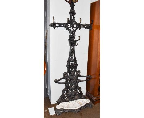 A Victorian Coalbrookdale style black painted cast iron hall stand with triple umbrella/stick section, with drop-in white pai