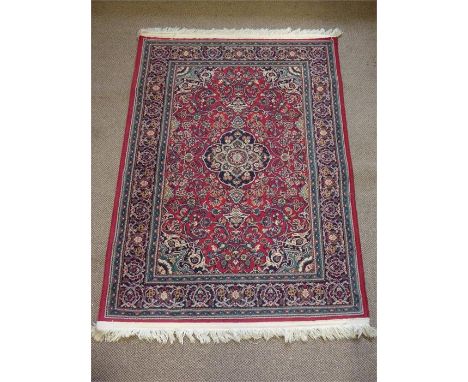 An Egyptian Wool Carpet, the carpet having navy blue patterned border, green/red ground with central medallion , approx 160 x