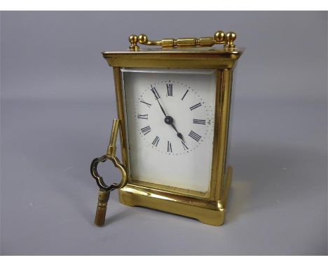 A Brass Carriage Clock, white enamel face with Roman numerals, approx 11 x 8 cms, Swiss SFRA, approx 8 x 7 x 10 cms