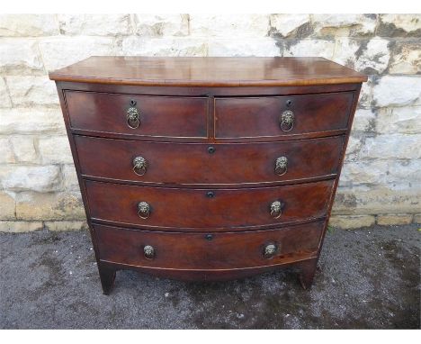 An Antique Bow-fronted Mahogany Chest of Drawers, having two short drawers and two long, with brass lion mask ring handles, r