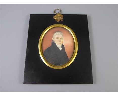A 19th Century Portrait Miniature, of a gentleman in a navy frock coat, approx 7 x 6 cms, stamped paper label to verso reads 