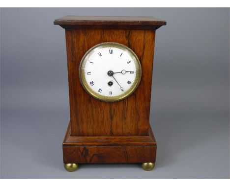 A Georgian Rosewood-Cased Library Clock, on brass ball feet, the clock having a white enamel face with Roman numerals and a f