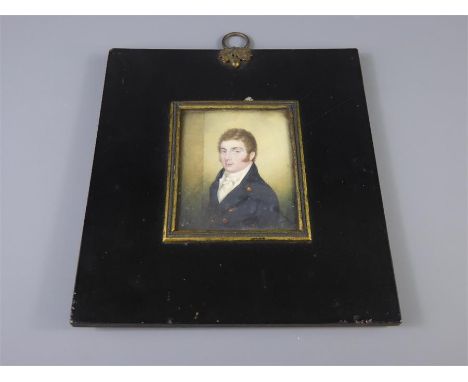 A 19th Century Portrait Miniature, a gentleman in navy overcoat, paper label to verso reads 'Goldsmiths Jewellery and Miniatu
