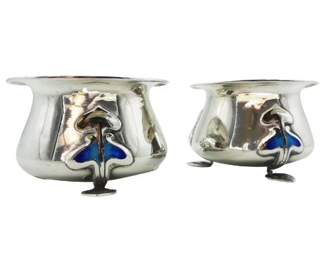 Pair of early 20th century Art Nouveau silver and enamel open salts, of bellied form with lipped rim, upon three stylised pad