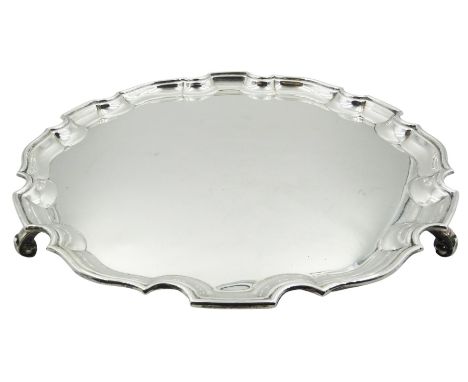 1930's silver salver, of circular form with pie crust edge, upon three scroll feet, hallmarked Adie Brothers Ltd, Birmingham 