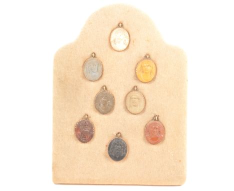 A collection of eight lava portrait cameos, yellow metal mounts, each approximately 3cm, mounted on a velvet board.Provenance