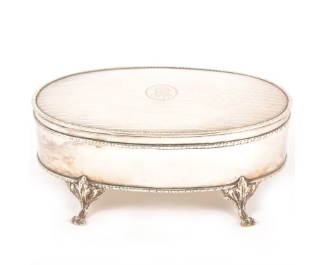 An Edwardian oval silver jewel box, Mappin &amp; Webb, Birmingham 1908, engine turned lid with engraved monogram, (replaced) 