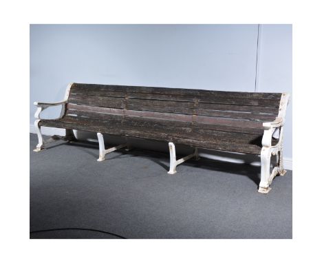 Garden bench, white painted cast iron scrolled ends, teak slats (defective), length 287cm.