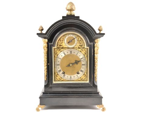 A German ebonised bracket clock, domed case with gilt brass mounts, scrolled feet, 6" arched brass dial with Roman chapter ri