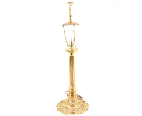 Cast brass table lamp, eagle finial, scrolled and fluted base, height 77cm.