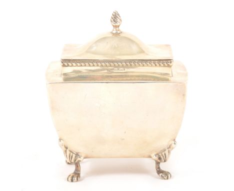An Edwardian silver tea caddy, Mappin &amp; Webb, London 1910, rectangular urn form, hinged domed lid with a flammeau finial,