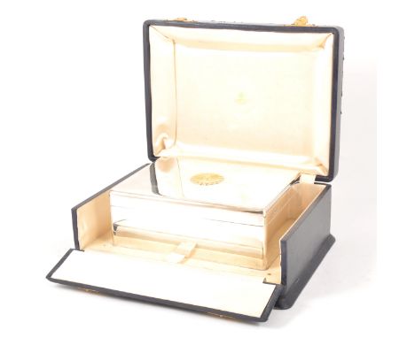 A silver box, J W Benson Limited, London 1920, oblong shape, with a gilt chrysanthemum symbol to the lid, 48oz, 19.5cm x 14cm