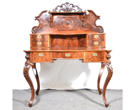 A Louis Philippe style mahogany writing table, the superstructure with scrolled back and shelf above drawers, serpentine rect