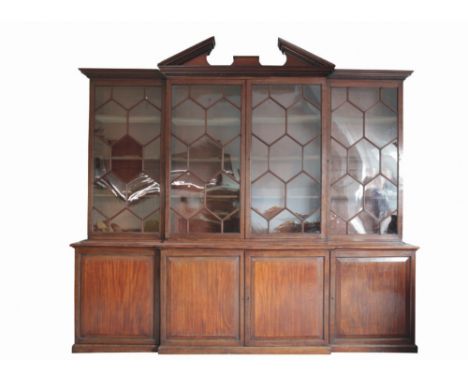 GEORGE III MAHOGANY BREAKFRONT LIBRARY BOOKCASE circa 1780 the dentil moulded cornice with a broken arch pedament above four 