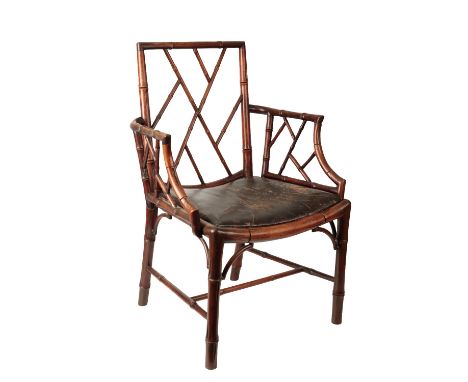 GEORGE III SIMULATED BAMBOO ELBOW CHAIR of Chinese Chippendale design with pale-work back and arms over a drop-in saddle seat
