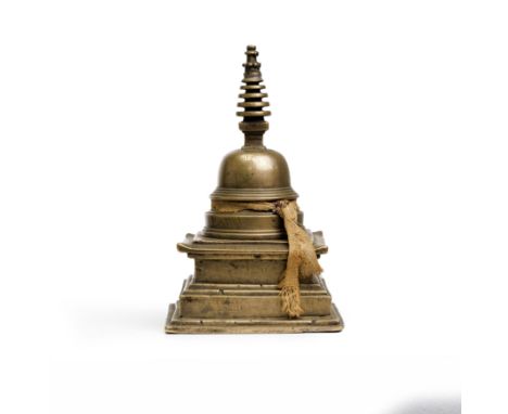 A Chinese copper-alloy stupaYuan/Ming dynastyTypically cast as a stepped square-section plinth surmounted by a circular dome,