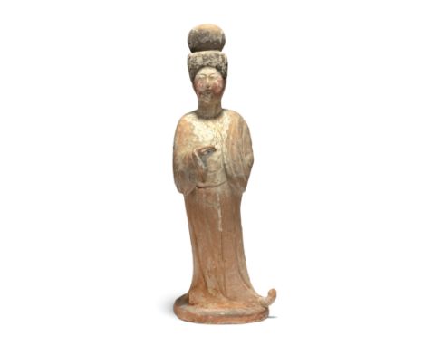 A Chinese pottery figure of a court ladyTang dynastyModelled standing, her right hand held in front of her chest, her left co