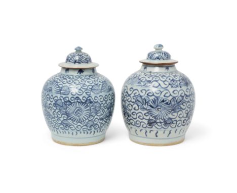 A pair of Chinese blue and white 'peonies' jars and coversQing dynasty, 19th centuryEach raised on short tapered foot, painte