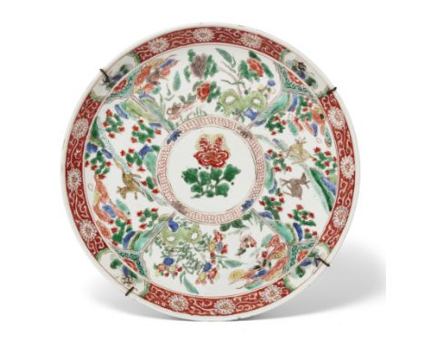 A Chinese famille verte 'animal and flower' dishQing dynasty, Kangxi periodPainted to the central roundel with a peony enclos