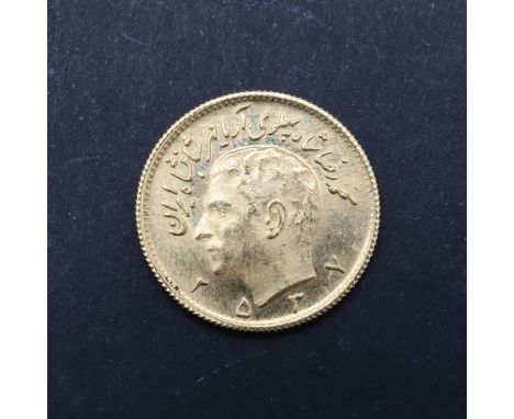 A Persian Half Pahlavi gold coin, bare head portrait l. reverse with sword carrying lion before a rising sun. 20mm c4.08g. *C