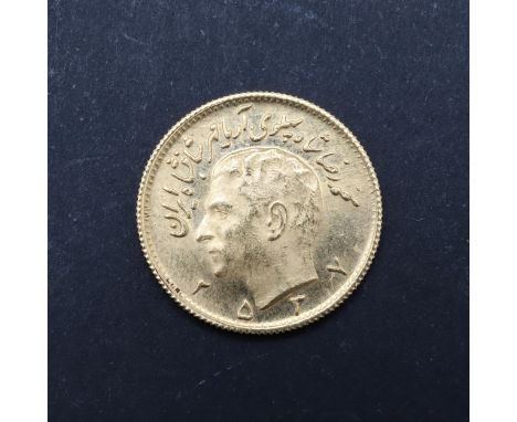 A Persian Half Pahlavi gold coin, bare head portrait l. reverse with sword carrying lion before a rising sun. 20mm c4.08g. *C