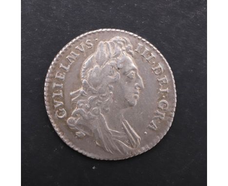 A William III Sixpence, first laureate and draped bust r. Reverse with cruciform crowned shields with smaller crowns and late