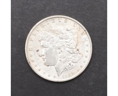 A Morgan type dollar, 1889. Bust of Liberty with wreath and date 1889, reverse eagle with wings outstretched. *CR A nice exam