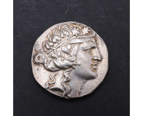 Silver Tetradrchm, obverse the head of a young Dionysos r. wreathed with ivy and with band across forehead. Reverse with stan