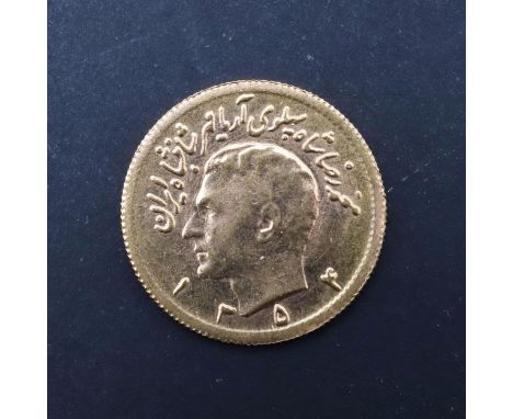 A Persian Half Pahlavi gold coin, bare head portrait l. reverse with sword carrying lion before a rising sun. 20mm c4.07g. *C