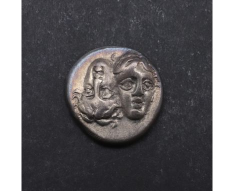 Silver Stater. Obverse with two young male heads facing, side by side, one upright, the other inverted. Reverse with a Sea Ea