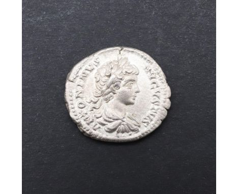 A silver Denarius, youthful laureate and draped bust r. Reverse Caracalla standing, naked, holding a globe and a spear. 3.03g