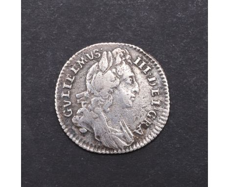 A William III Sixpence, first laureate and draped bust r. Reverse cruciform shield with large crowns and early harp, dated 16