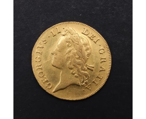 A George II Guinea, second young laureate head l. larger lettering. Reverse with crowned shield of arms and date 1735. *CR A 